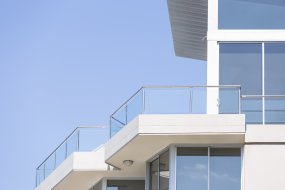 Closeup-modern-apartment-building-against-blue-sky,-copy-space-000075396623_Double.jpg